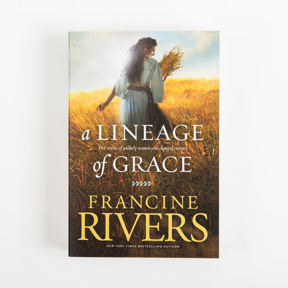 Front cover of A Lineage of Grace by Francine Rivers on a white background. A woman with long, dark wavy hair wears a pale blue-gray robe cinched with a brown sash and walks through a sunlit golden wheat field, glancing back over her shoulder while holding wheat stalks. White serif title text reads A Lineage of Grace, subtitled Five stories of unlikely women who changed eternity, followed by the author's name in gold and a New York Times Bestselling Author label.