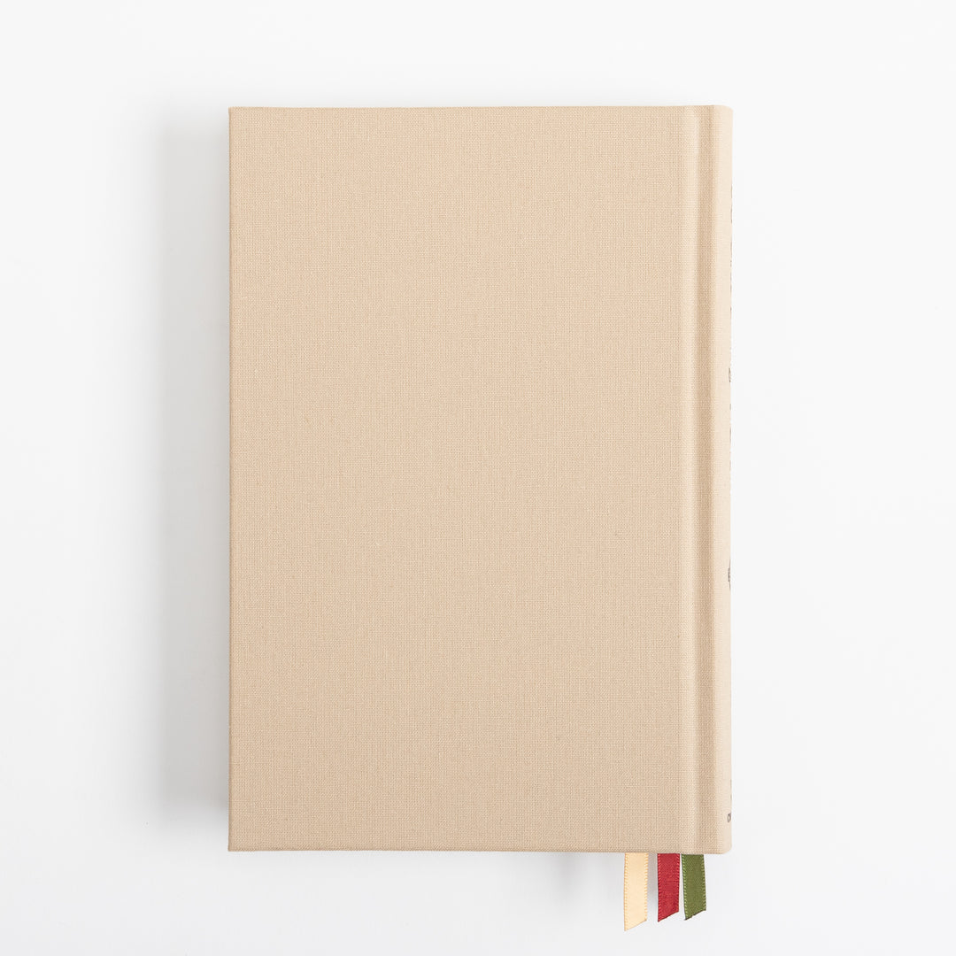 Straight-on view of the plain tan linen back cover, unadorned aside from its woven fabric texture, with three ribbon markers - cream, red, and olive green - visible tucked along the bottom edge near the spine.