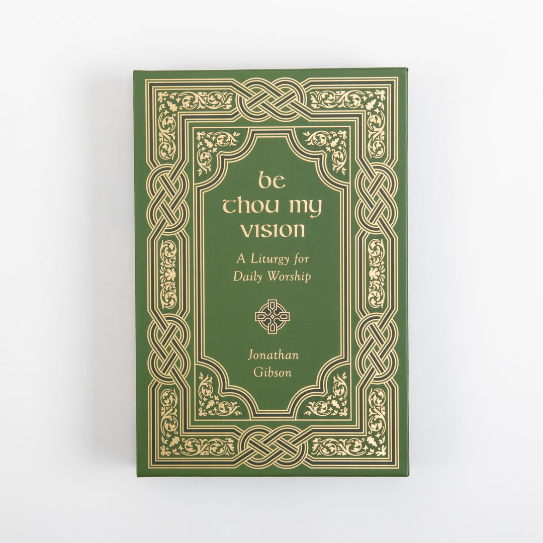 Straight-on view of the green slipcase front, framed by an ornate gold Celtic knotwork and foliate border. Centered inside are the gold title &