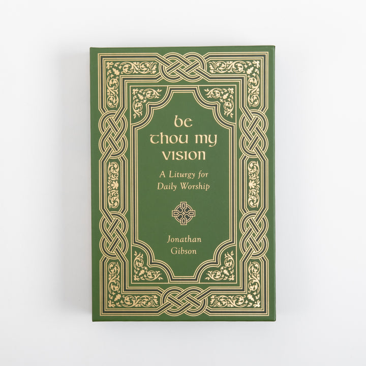 Straight-on view of the green slipcase front, framed by an ornate gold Celtic knotwork and foliate border. Centered inside are the gold title &