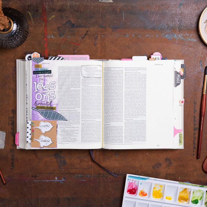 ESV Journaling Bible - Red Letter - Flowers – open Bible with colorful art journaling collage watercolor palette and paintbrush – lifestyle flat lay