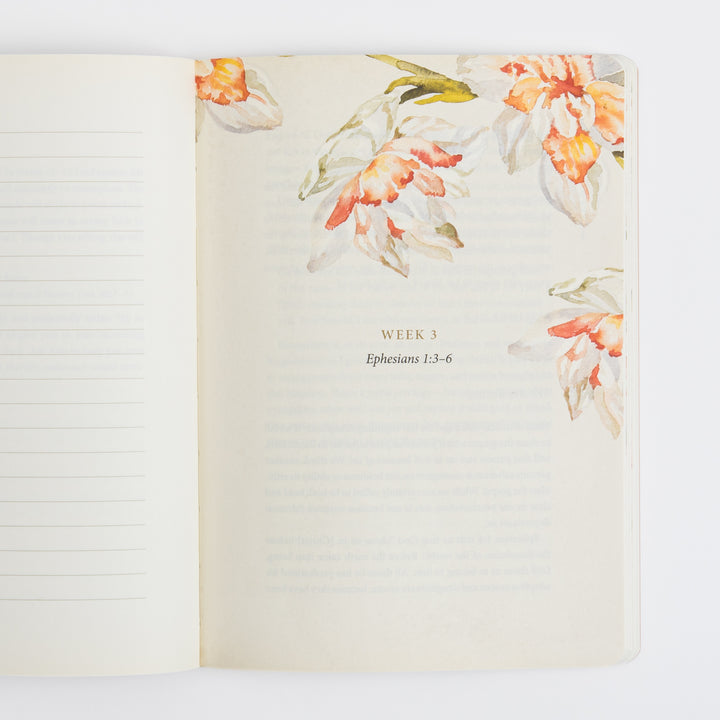 Open interior spread with a blank ruled journaling page on the left and a Week 3 section-divider page on the right featuring watercolor daffodil illustrations in the corners, the heading "WEEK 3," and the subtitle "Ephesians 1:3-6" over faintly visible scripture text.