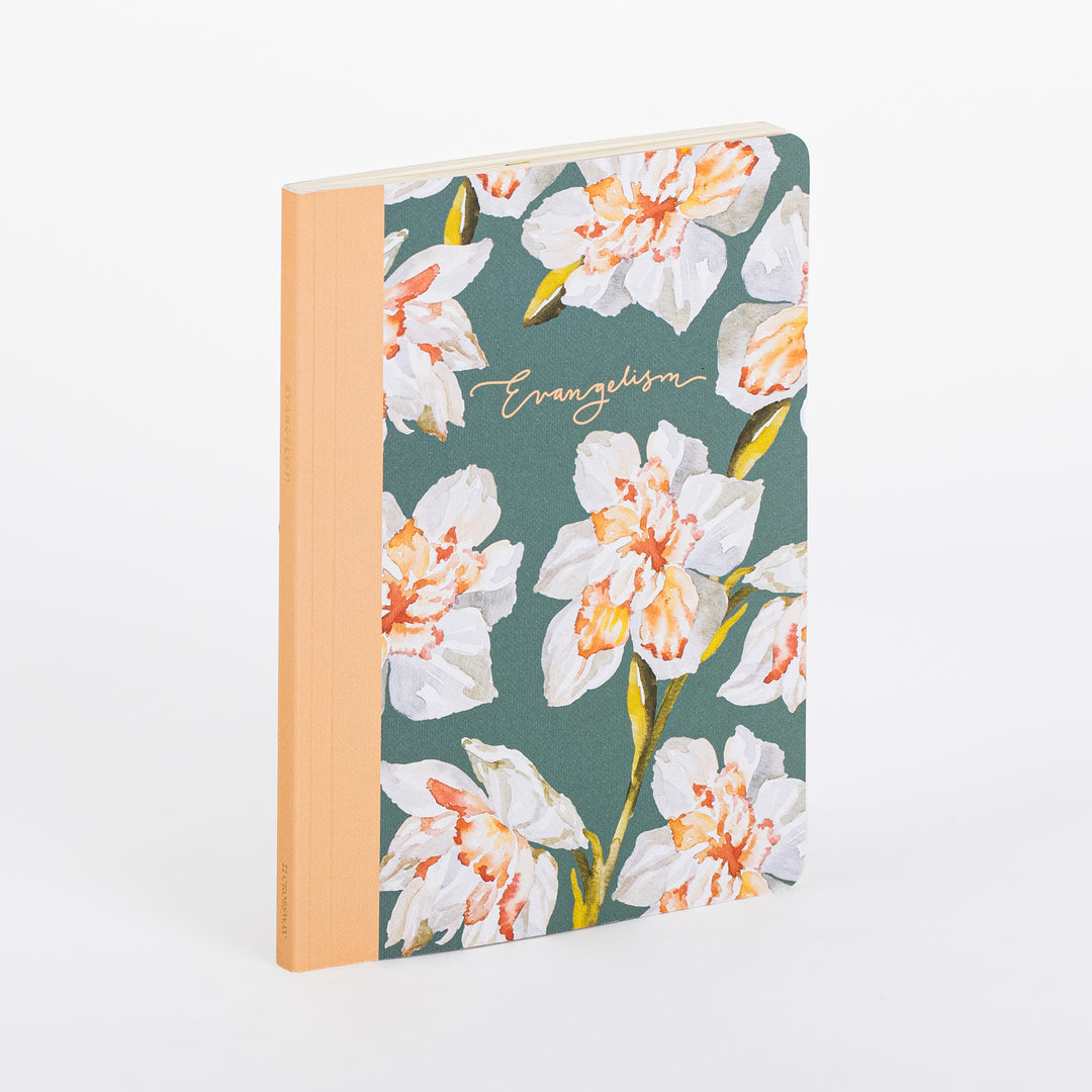 ESV Prayer Journal: 30 Days on Evangelism shown at an angle, standing upright. The softcover has a sage green fabric cover printed with a watercolor pattern of white and peach daffodils, a peach cloth spine, and the word "Evangelism" in gold script lettering on the front.