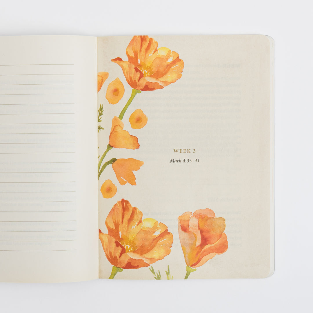 Open interior spread of the journal showing a blank cream-colored ruled page on the left for handwritten prayers, and on the right a &