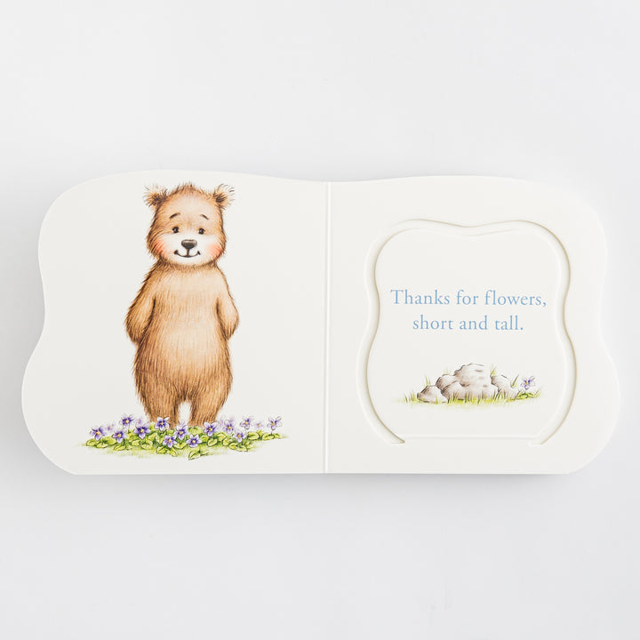 Great and Small Prayers for Babies – open shaped board book showing illustrated bear standing in purple violet flowers on left and die-cut prayer page reading Thanks for flowers short and tall with rock garden on right – interior prayer spread