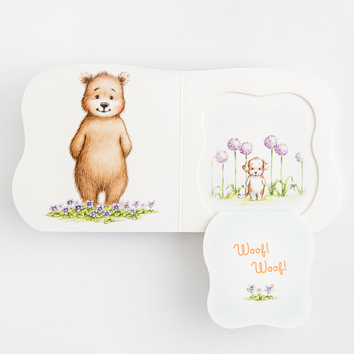 Great and Small Prayers for Babies – multiple shaped die-cut pages fanned open showing bear in violet flowers a puppy among purple allium flowers and Woof Woof page with small violet – interior pages fanned view