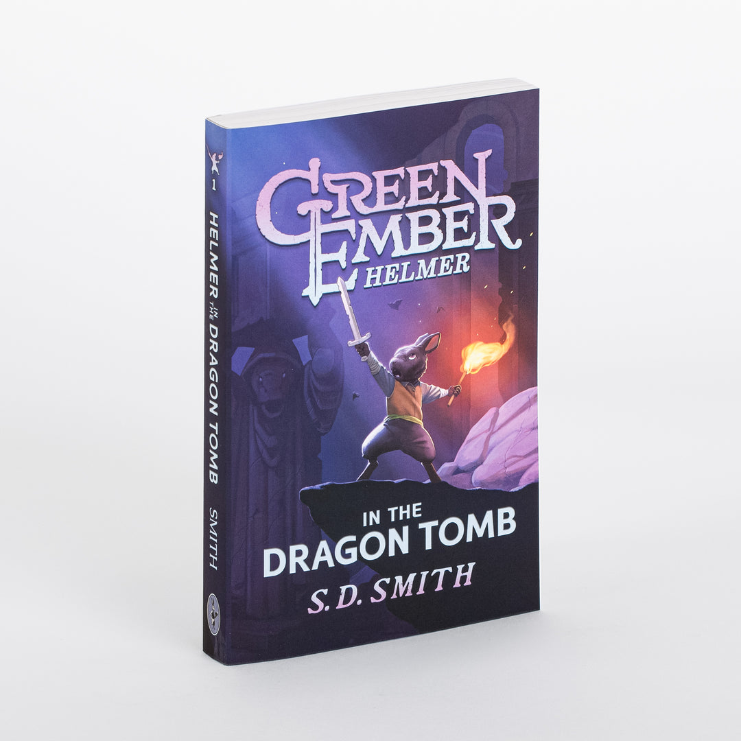 Angled view of the paperback cover of Green Ember: Helmer in the Dragon Tomb by S.D. Smith, showing a rabbit warrior raising a sword and holding a flaming torch on a rocky ledge before ancient purple-lit stone columns.