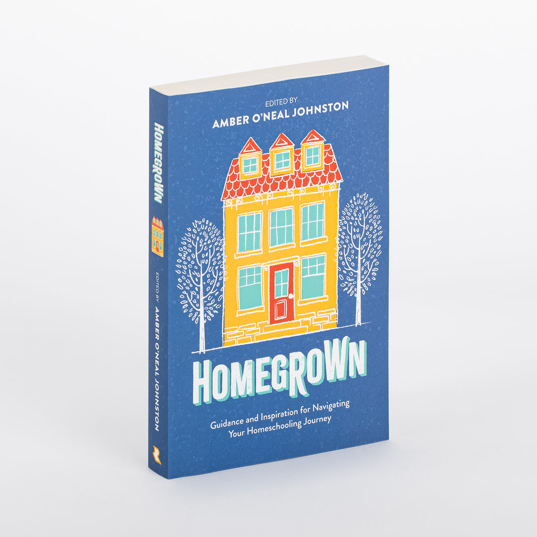 Angled three-quarter view of the paperback book Homegrown, edited by Amber O'Neal Johnston, showing the blue front cover illustrated with a yellow two-story row house between bare trees, and the spine reading HOMEGROWN in white lettering.