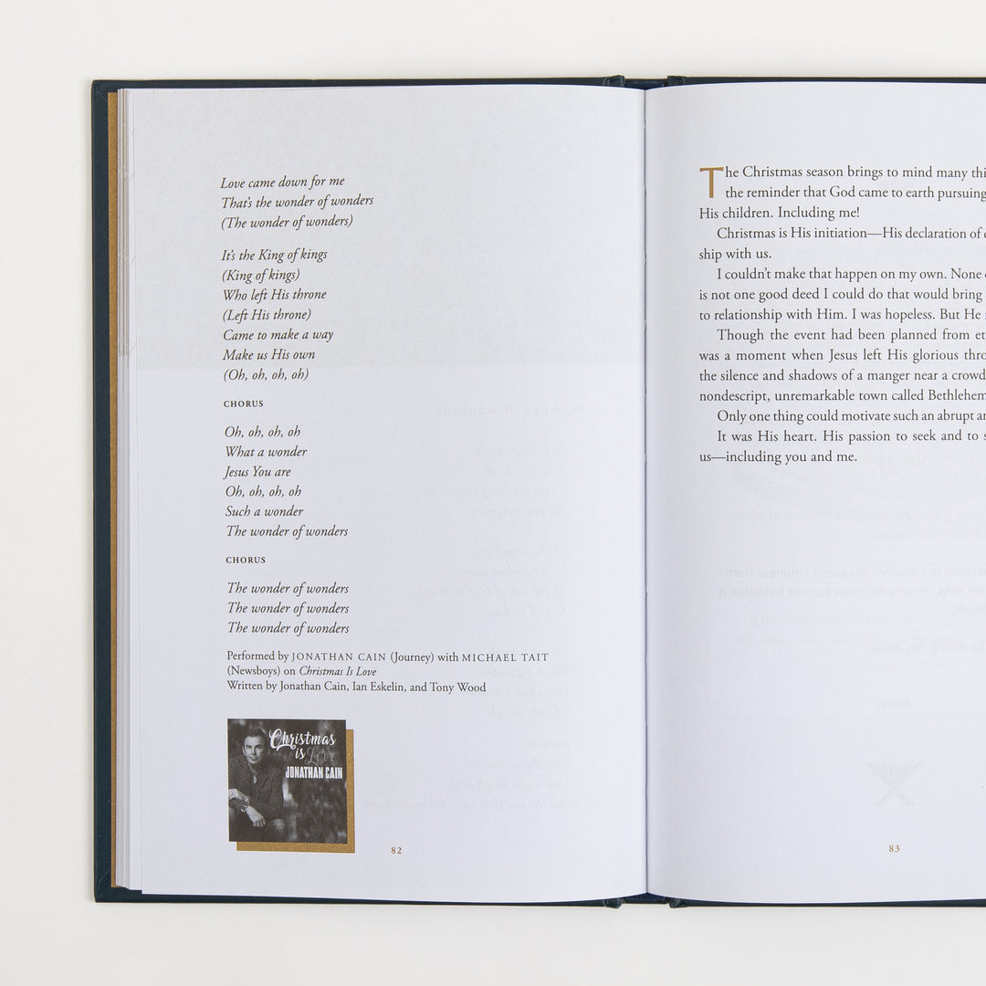 Open book spread, pages 82-83: left page continues lyrics to "Wonder of Wonders" with performance credits for Jonathan Cain and Michael Tait and a small album cover thumbnail for "Christmas Is Love"; right page begins an essay starting "The Christmas season brings to mind..."