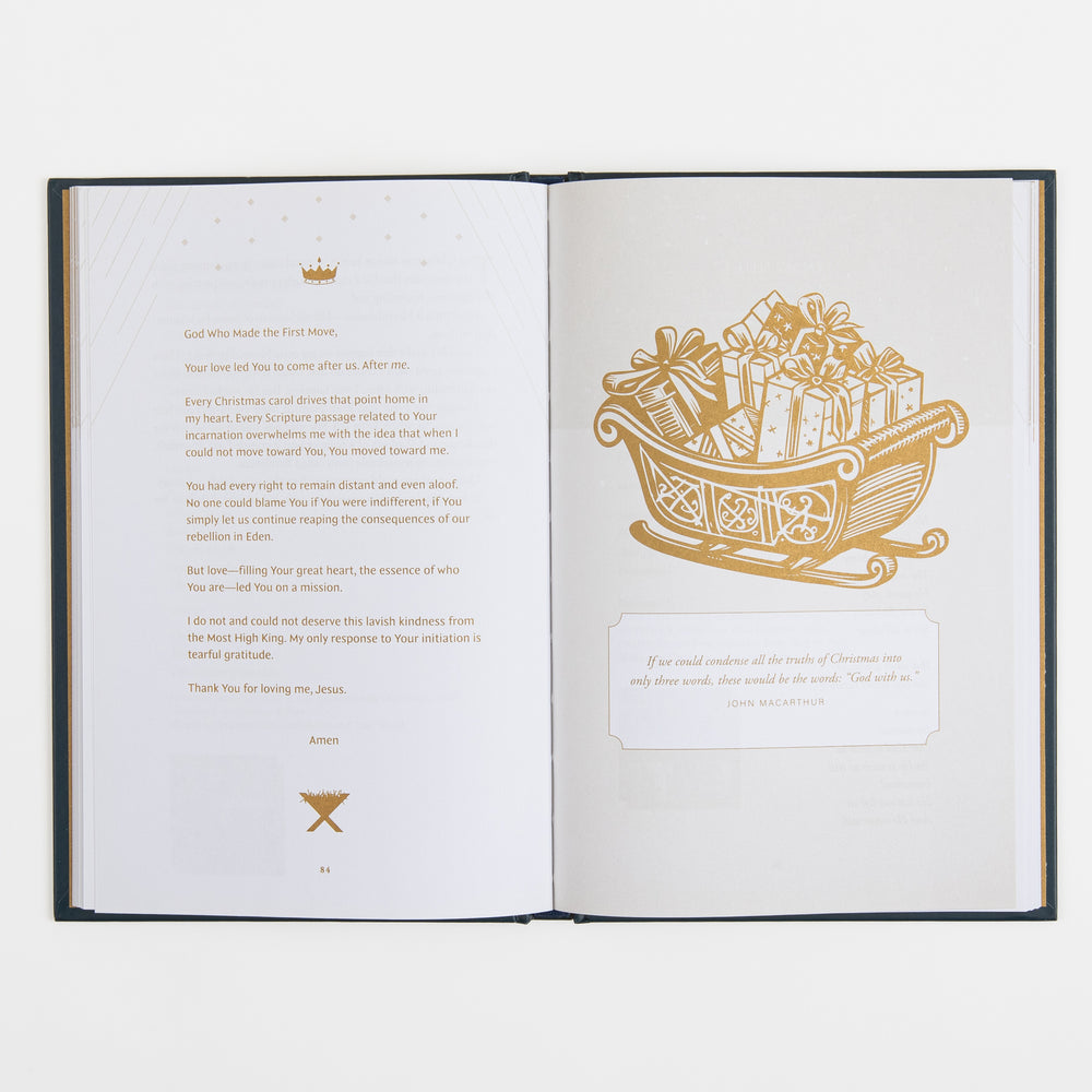 Open book spread: left page shows a devotional prayer titled "God Who Made the First Move" ending "Thank You for loving me, Jesus," beneath a gold crown icon; right page shows a gold line-art sleigh piled with wrapped gifts above a boxed quote from John MacArthur about "God with us."