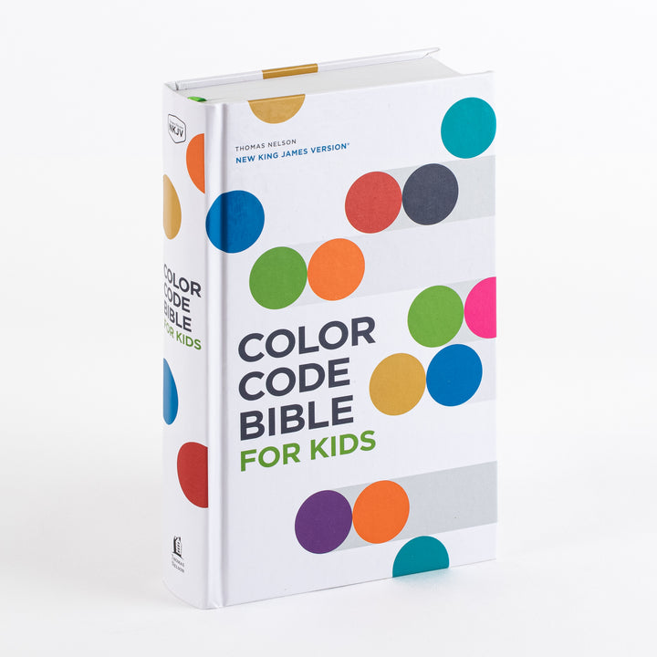 Three-quarter view of the NKJV Color Code Bible for Kids hardcover, a white cover with colorful circles and the title Color Code Bible for Kids, spine and green ribbon marker visible.