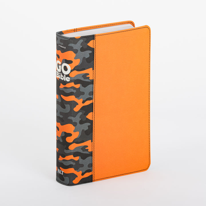 Three-quarter angle view of the NLT GO Bible for Kids standing upright, showing its orange leatherlike front cover and black-and-orange camouflage spine with the GO Bible logo and NLT wordmark.