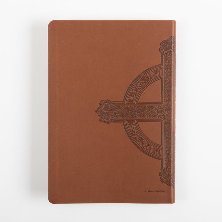 Back cover of the Bible lying flat, in brown leatherlike material with the right half of the embossed Celtic-style cross design continuing from the spine, plain surface elsewhere, and small ISBN text printed near the bottom right corner.