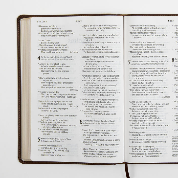 Open Bible spread showing Psalms 4 through part of Psalm 7 in large-print two-column text, with musical performance notes such as &