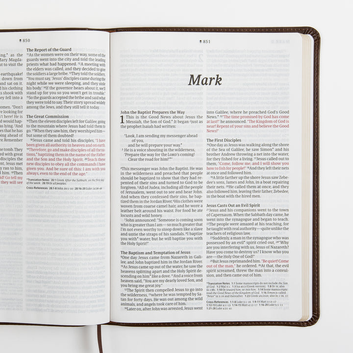 Open Bible spread showing the end of Matthew and the title page for the Gospel of Mark, with the words of Jesus printed in red, large-print two-column text, and translation notes and cross-references at the bottom.