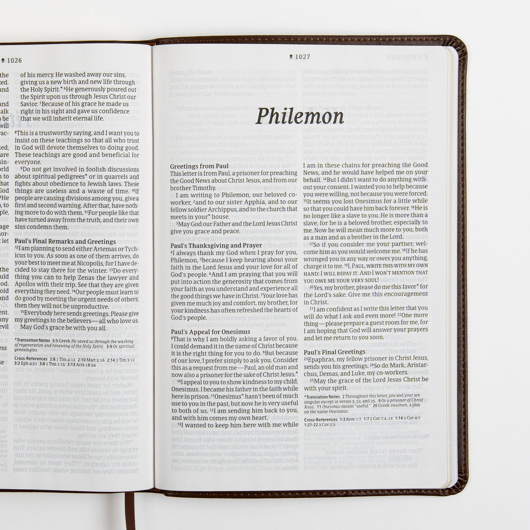 Open Bible spread showing the complete short book of Philemon on a two-page spread, with the title page and full text in large-print two-column format, plus footnotes and cross-references.