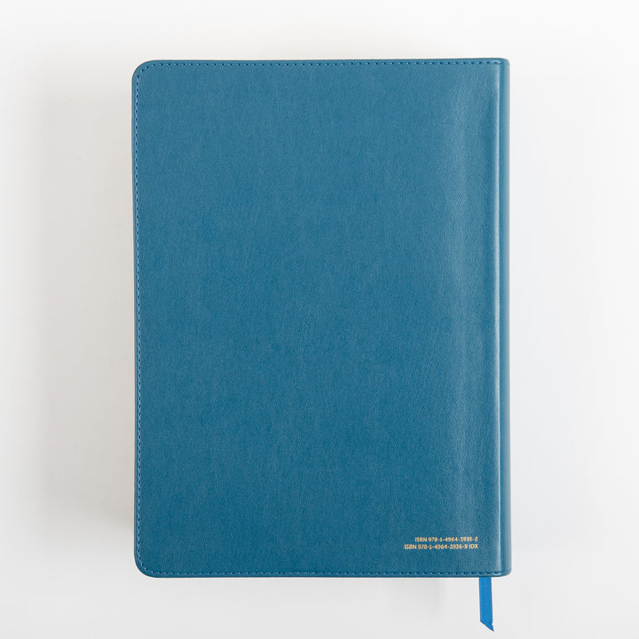 Back cover of the teal leatherlike Bible, plain and unembossed except for small gold ISBN numbers printed in the lower right corner, with a teal ribbon marker hanging from the bottom edge.