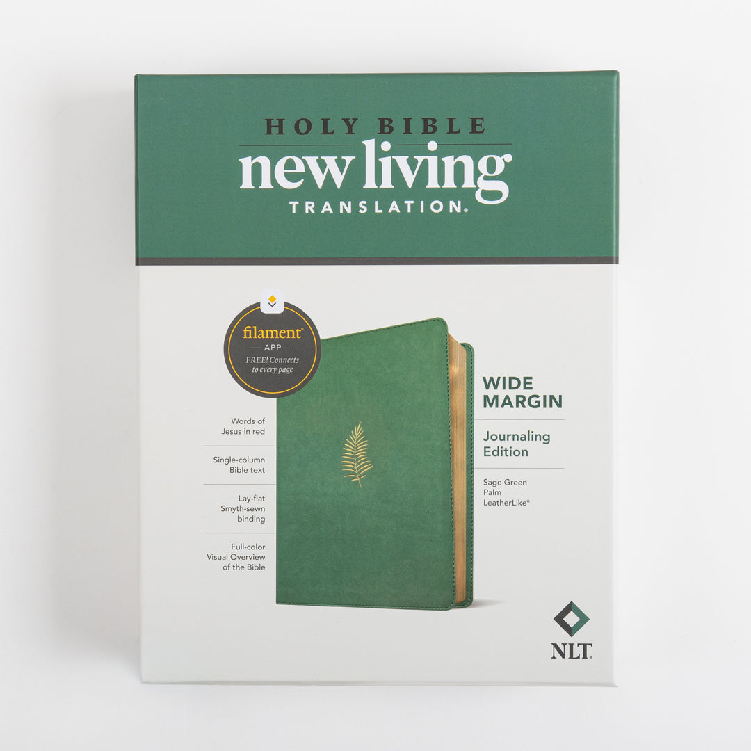 Front of the retail box for the NLT Wide Margin Bible, Filament Enabled, showing the Holy Bible New Living Translation logo, a Filament app badge, a feature list including words of Jesus in red and lay-flat Smyth-sewn binding, and the sage green palm leatherlike Bible standing beside the box, labeled Wide Margin Journaling Edition.