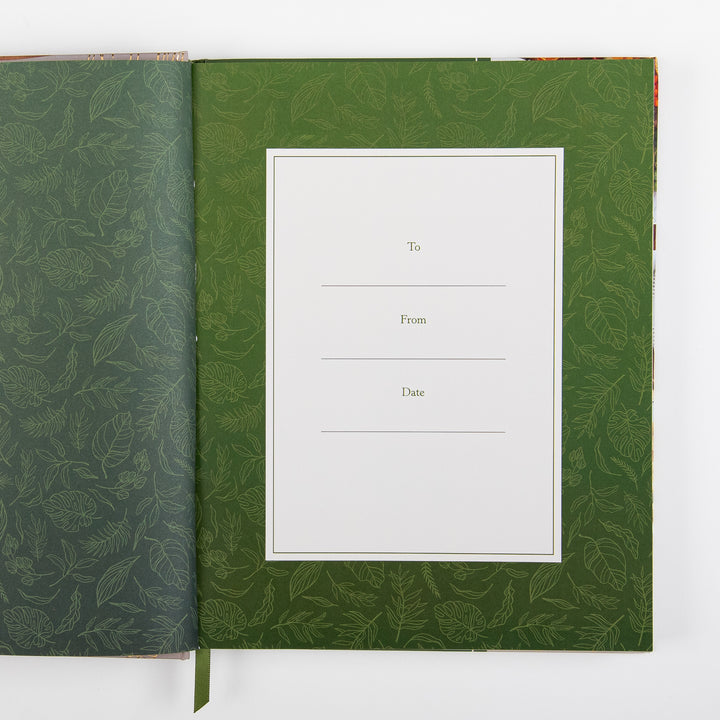 Interior page of the devotional cookbook showing a blank gift inscription page with To, From, and Date lines on cream paper bordered by a green leaf-pattern background.