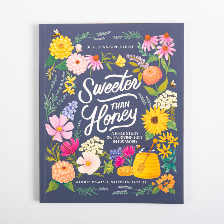 Front cover of Sweeter Than Honey: A Bible Study on Enjoying God in His Word, shown flat. A navy blue background is ringed with hand-painted wildflowers (zinnias, coneflowers, sunflowers, cosmos, lavender) and bees, centered on a honey pot with dripping dipper and honeycomb; white script title reads &