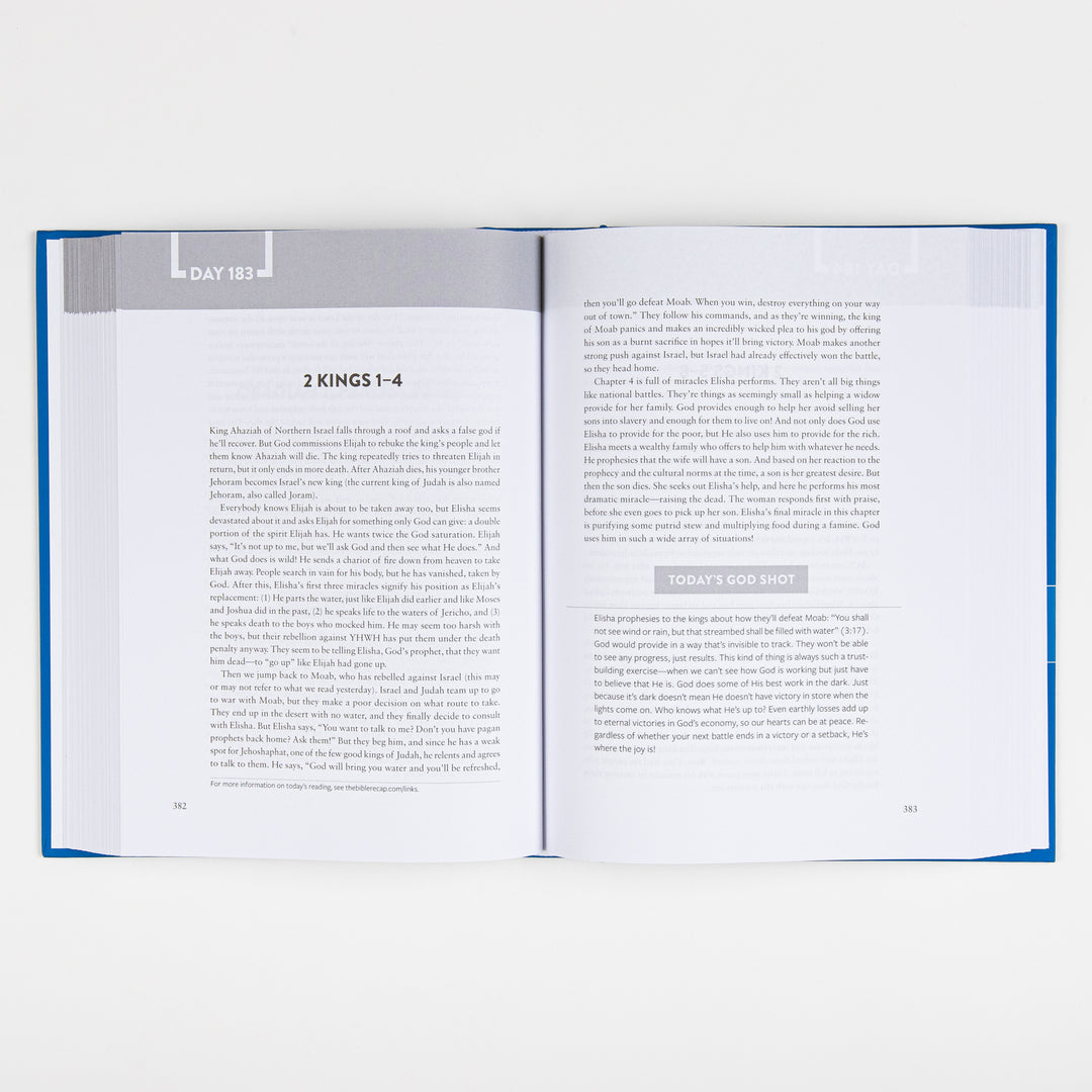 The Bible Recap book lying open to Day 183 on 2 Kings 1-4, shown from further back with the full two-page layout and "Today&