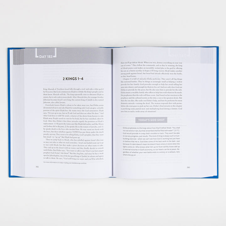 The Bible Recap book lying open to Day 183 on 2 Kings 1-4, shown from further back with the full two-page layout and "Today&