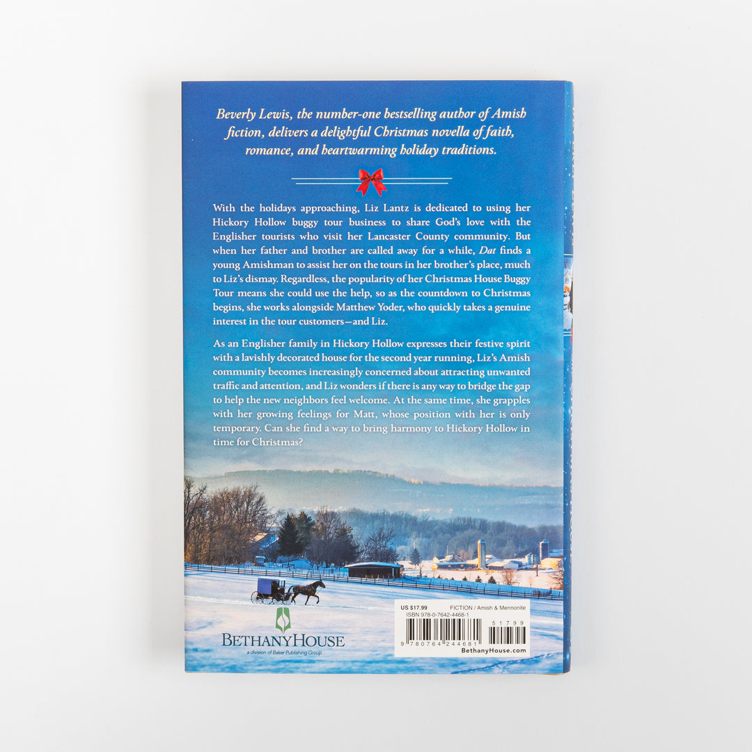 Back cover of The Christmas House by Beverly Lewis, with white plot summary text on a blue background above a snowy Lancaster County photo of a horse-drawn buggy on a farm road, plus the Bethany House logo and barcode.