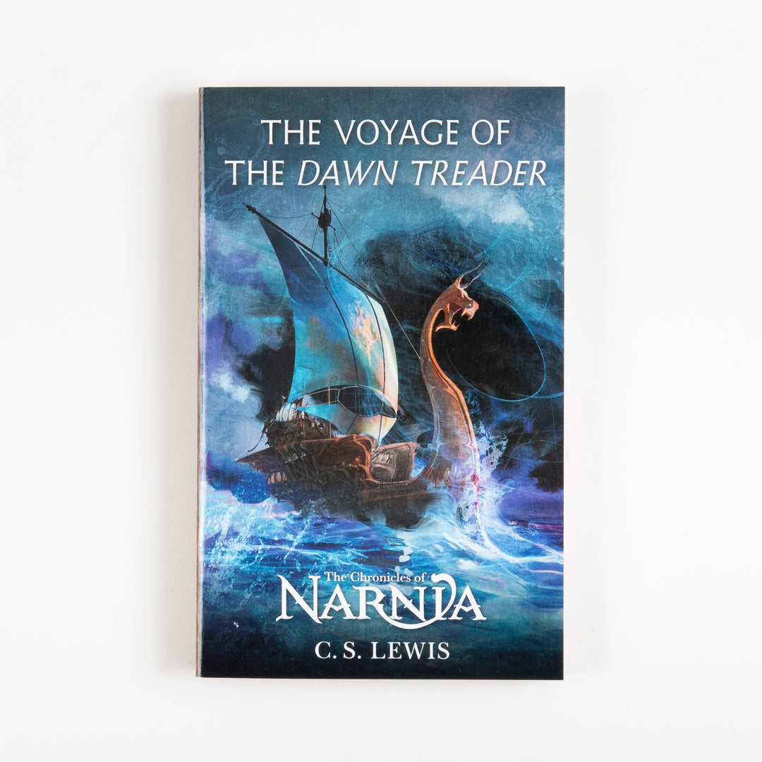Front cover of The Voyage of the Dawn Treader, book five of The Chronicles of Narnia by C.S. Lewis, showing the ship Dawn Treader under sail beside a rearing sea serpent against a stormy blue sky.