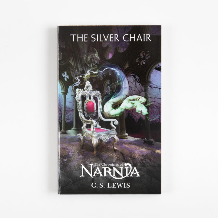 Front cover of The Silver Chair, book six of The Chronicles of Narnia by C.S. Lewis, showing an ornate silver throne with a glowing green serpent coiling around it in a shadowy purple hall.