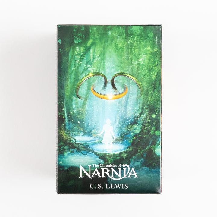 End panel of The Chronicles of Narnia box set showing a green forest scene with a glowing golden portal ring and a translucent white figure wading through a pool of water, with the series logo and C.S. Lewis&