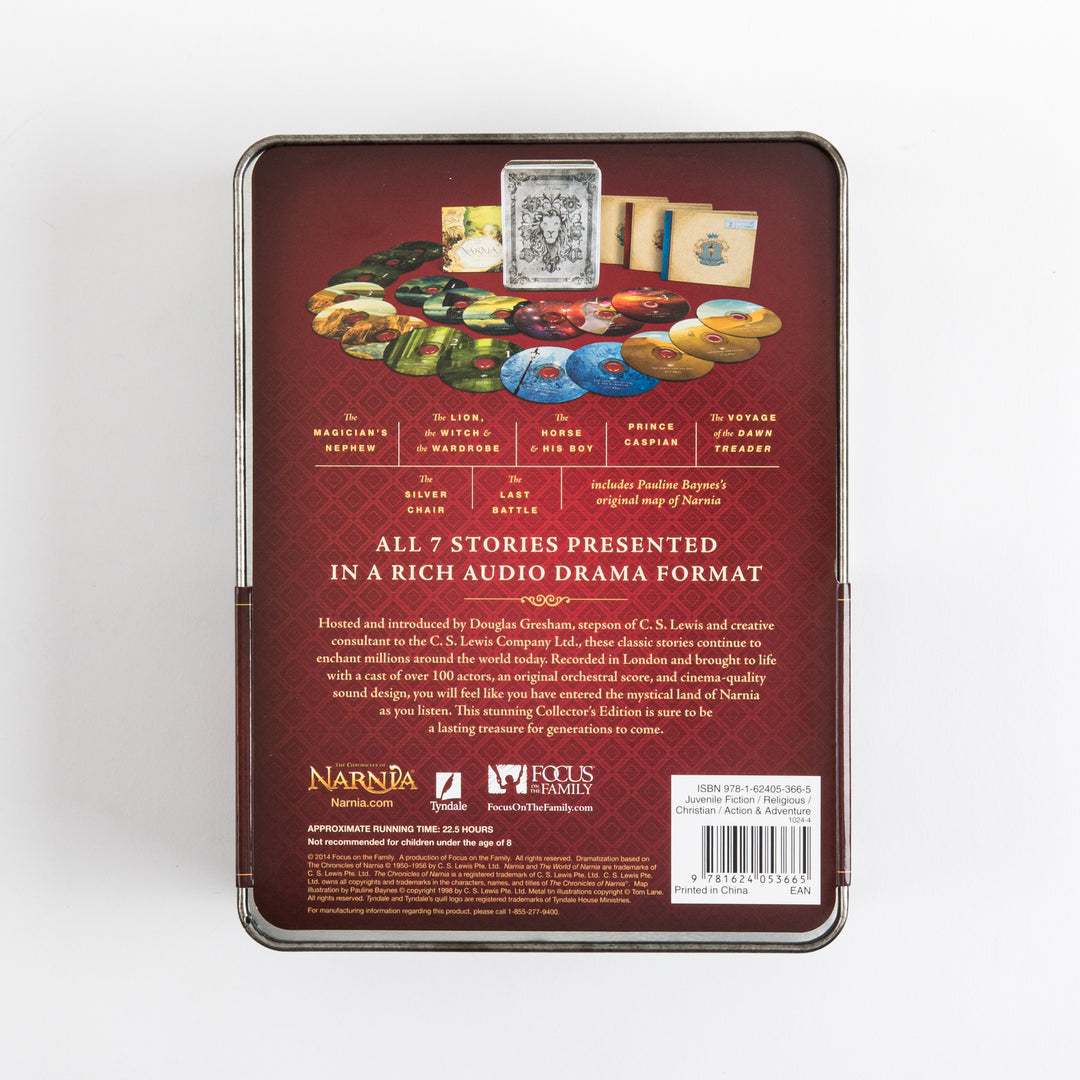 Back of the tin box on a dark red background, showing a fanned arc of colorful CDs and book sleeves beneath a small photo of the silver lion tin, listing all seven titles (The Magician&