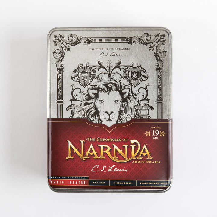 Front of the Chronicles of Narnia Radio Theatre tin box with the paper wrap band still on, showing the engraved silver lion lid above a red banner reading &