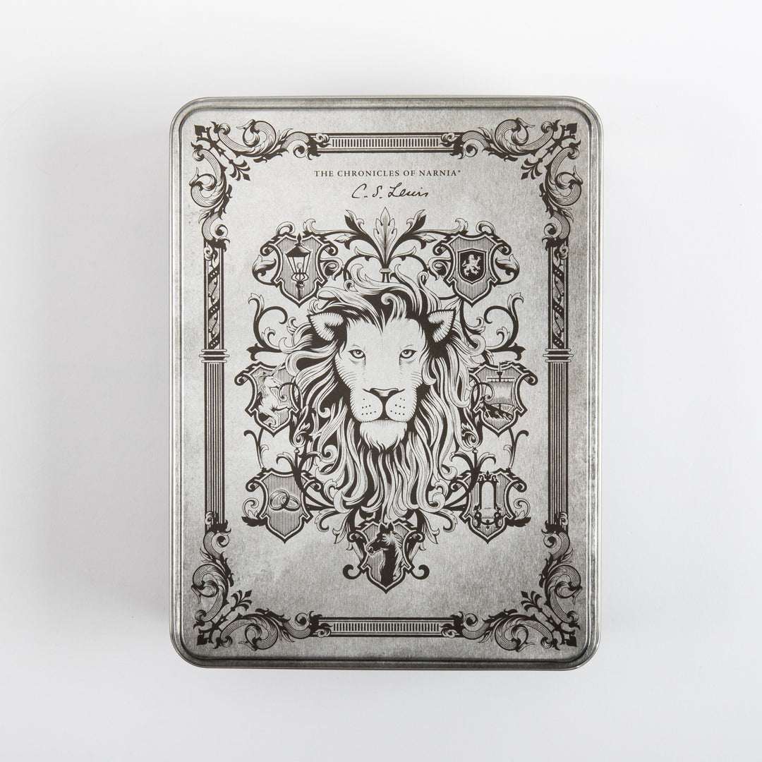 Straight-on top view of the closed silver tin lid, engraved with a detailed lion&