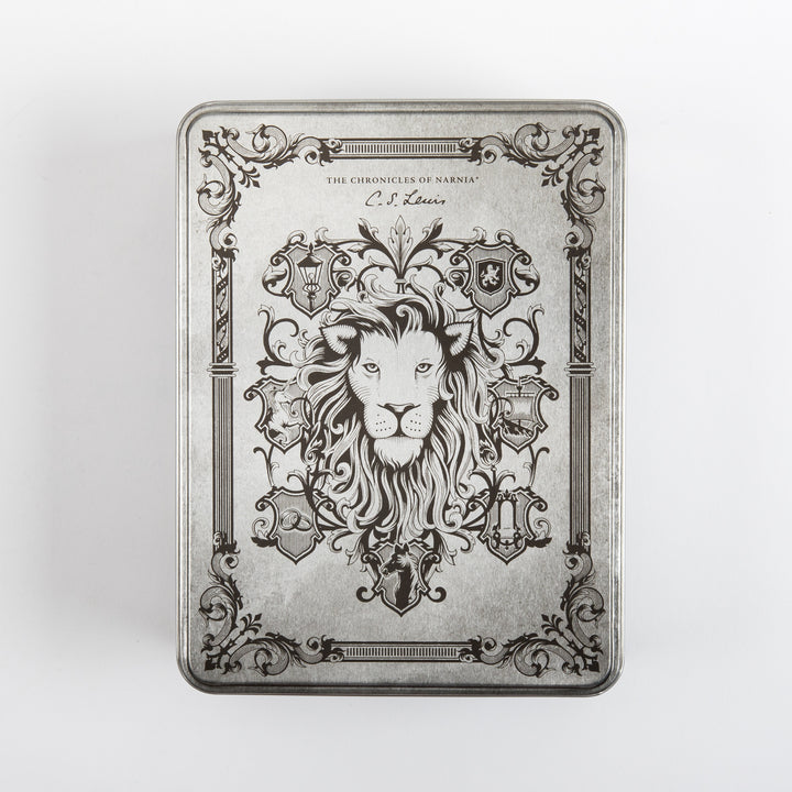 Straight-on top view of the closed silver tin lid, engraved with a detailed lion&