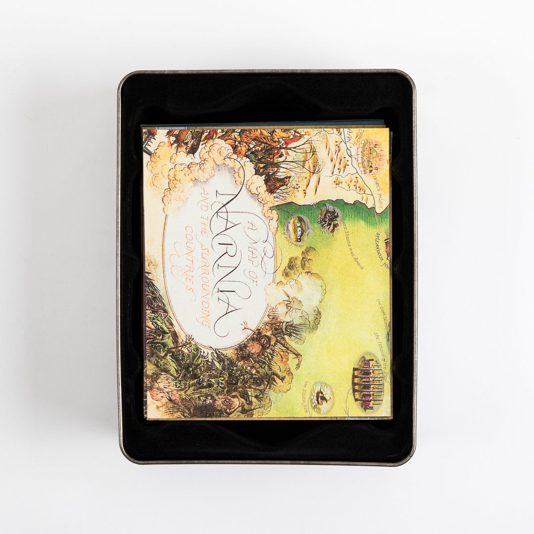 Overhead view into the tin case showing the folded illustrated map tucked inside, its visible portion reading &