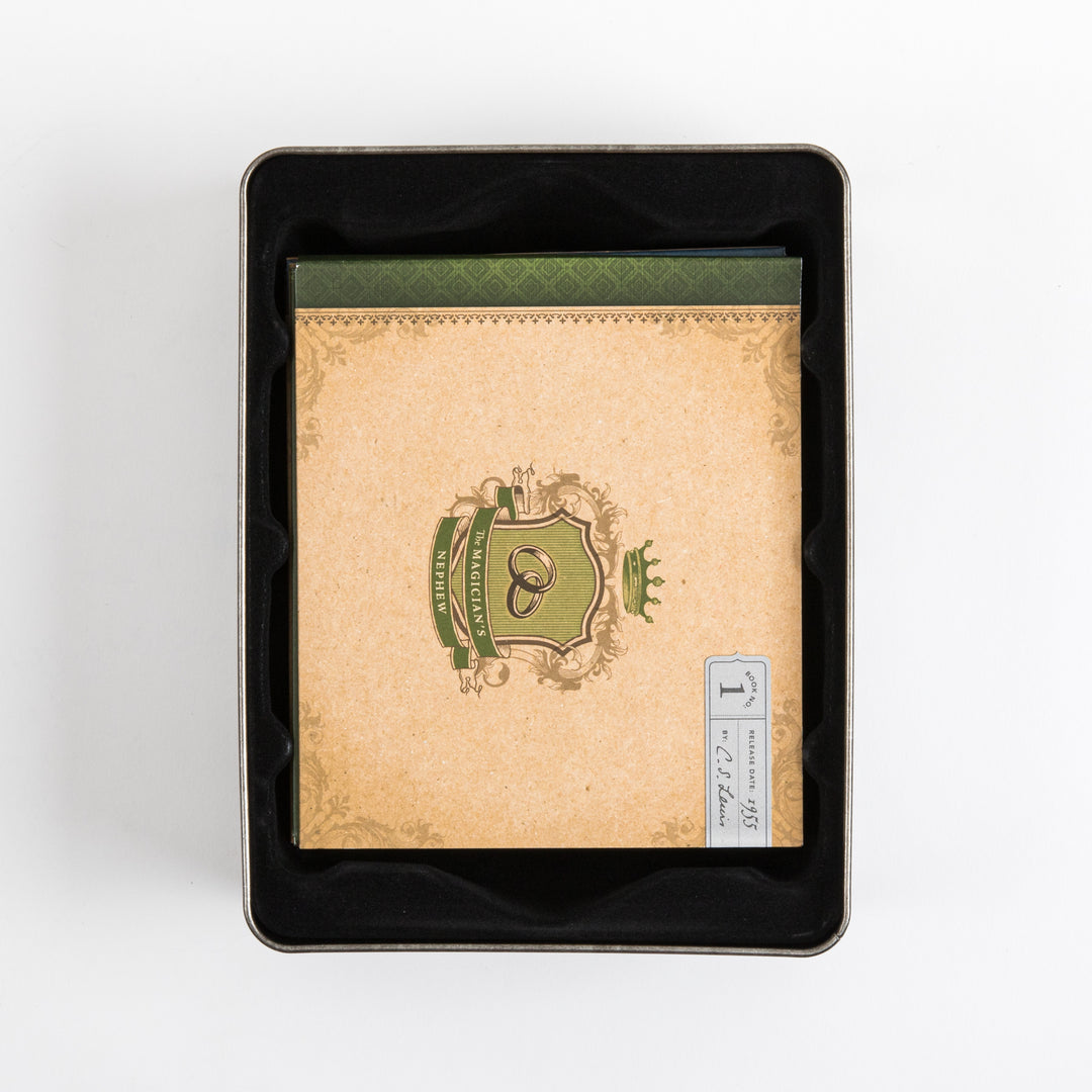 Overhead view into the open tin case, showing the top book sleeve for &