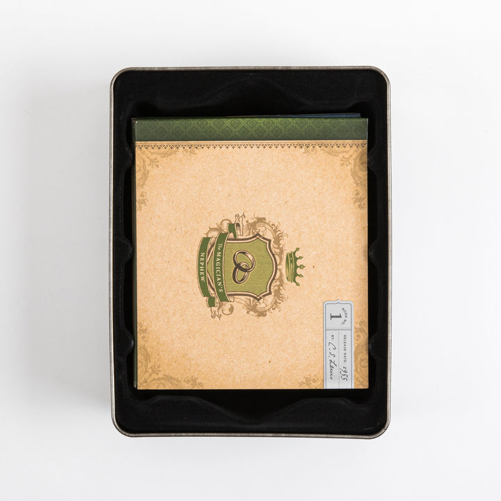 Overhead view into the open tin case, showing the top book sleeve for &
