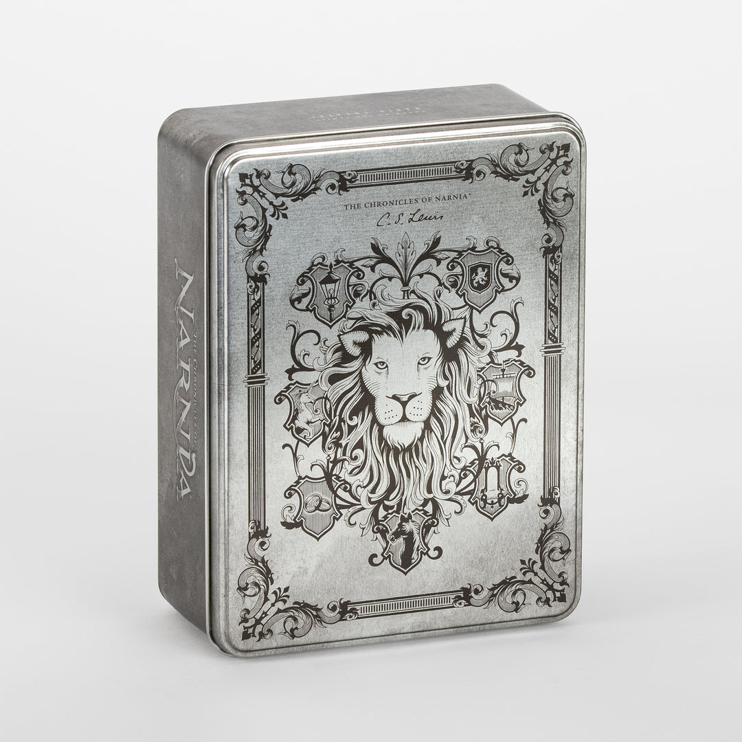 Angled three-quarter view of the closed Narnia Radio Theatre tin, engraved silver lid showing a detailed lion&