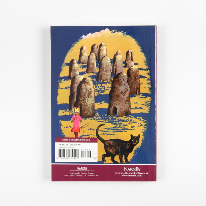 Back cover of the full-color paperback edition of The Horse and His Boy, showing a ring of ancient standing stones under a golden sky, a small pink-robed monkey figure, and a black cat, with a price sticker and barcode.