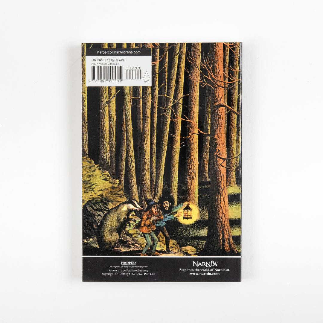 Back cover of the full-color paperback edition of Prince Caspian, showing a dark forest scene with a boy, a badger, and a glowing lantern, with a price sticker and barcode at the top.