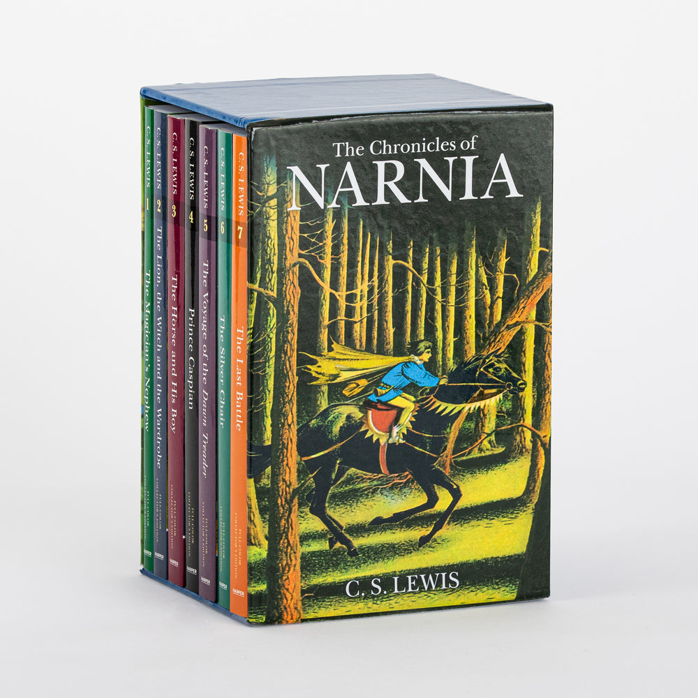 Three-quarter view of the Chronicles of Narnia full-color paperback box set rotated to show the back panel, illustrated with a caped rider galloping through a dark pine forest, with the seven paperback spines visible along the left edge.