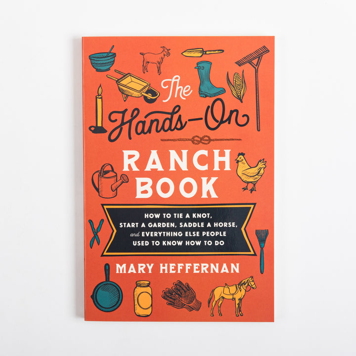 Front cover of The Hands-On Ranch Book by Mary Heffernan, flat-on view: orange cover with hand-drawn icons of a goat, chicken, saddled horse, wheelbarrow, rain boots, corn, rake, candle, watering can, skillet, mason jar, and gloves surrounding the navy-and-cream title and subtitle.