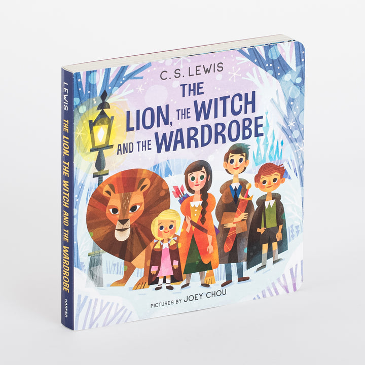 Board book cover for The Lion, the Witch and the Wardrobe by C.S. Lewis, shown at a three-quarter angle. Illustration by Joey Chou shows Aslan the lion beside Lucy, Susan, Peter, and Edmund in winter coats, standing before a lit lamppost in a snowy forest. The spine reads LEWIS and the title, with a Harper logo at the base.