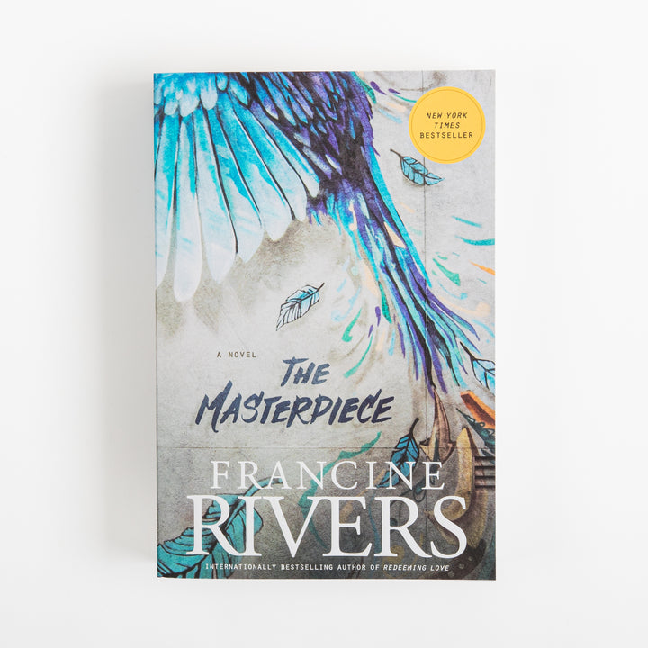 Front cover of the paperback The Masterpiece by Francine Rivers, shown straight-on. A teal, turquoise, and purple painted bird wing spreads diagonally across a gray, concrete-like textured background, with small feather illustrations floating nearby and a yellow New York Times Bestseller sticker in the upper right corner. The title is in bold navy brush-script lettering above the author&