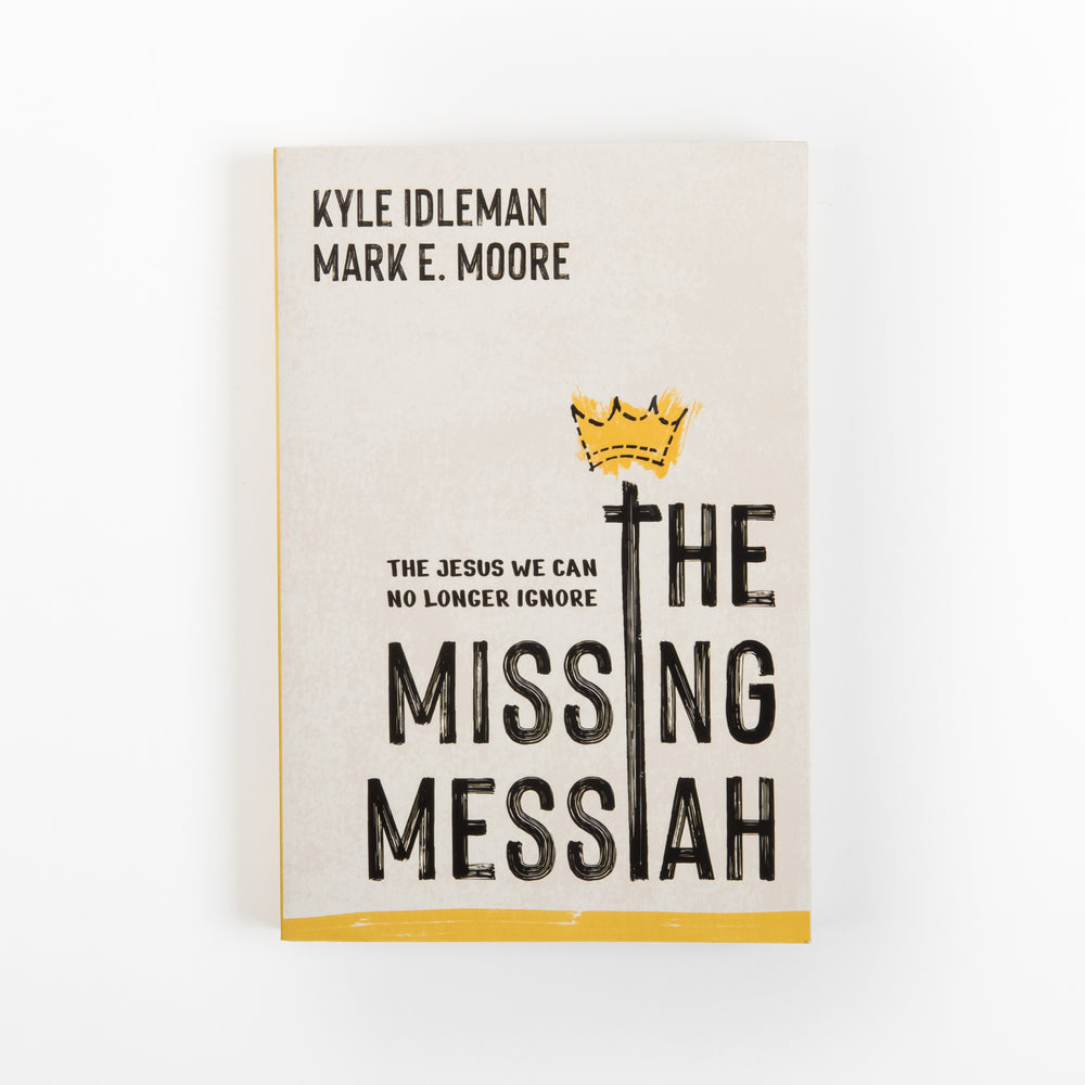 Flat front cover of 'The Missing Messiah: The Jesus We Can No Longer Ignore' by Kyle Idleman and Mark E. Moore. Cream background with the authors' names at top, a hand-drawn yellow crown atop a black cross that doubles as the letter I in 'MISSING,' bold black hand-lettered title text, and a yellow stripe along the bottom edge.