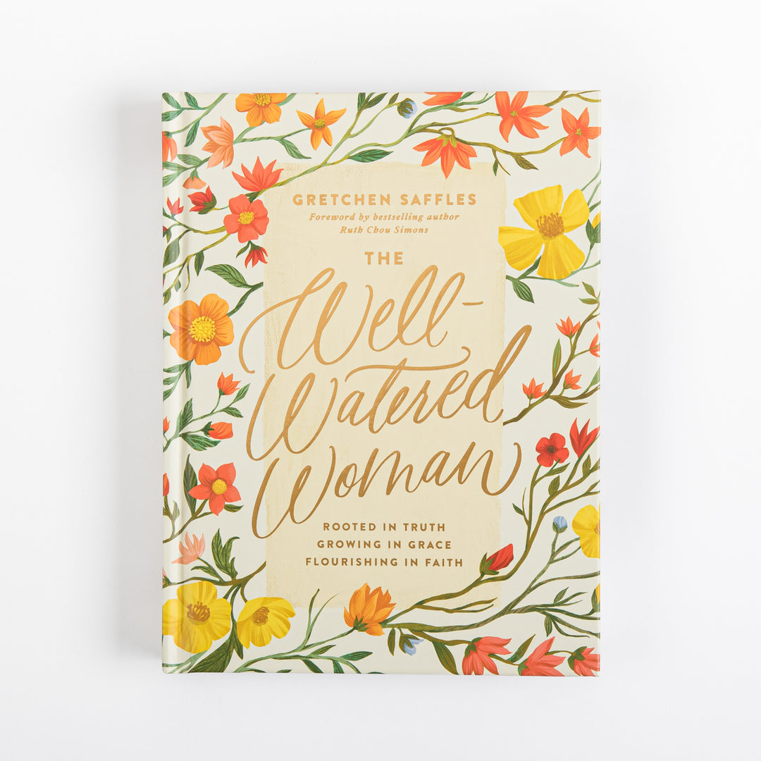 Front cover of The Well-Watered Woman by Gretchen Saffles, foreword by Ruth Chou Simons, featuring a cream background bordered with hand-painted yellow, orange, and red wildflowers and green leafy vines, with the title in gold script and subtitle Rooted in Truth, Growing in Grace, Flourishing in Faith.