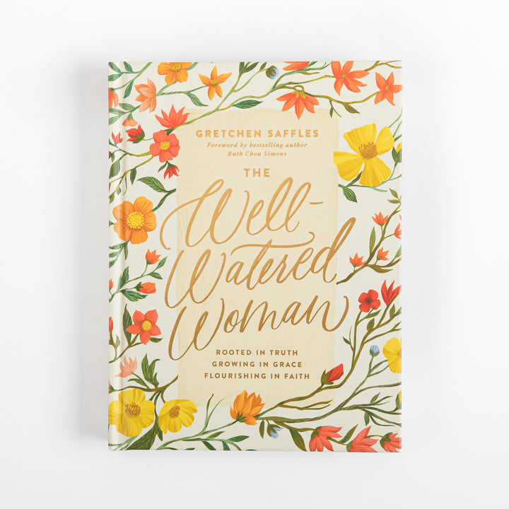 Front cover of The Well-Watered Woman by Gretchen Saffles, foreword by Ruth Chou Simons, featuring a cream background bordered with hand-painted yellow, orange, and red wildflowers and green leafy vines, with the title in gold script and subtitle Rooted in Truth, Growing in Grace, Flourishing in Faith.