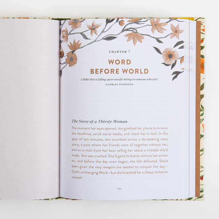 Open book spread showing the start of Chapter 7, Word Before World, topped with a peach floral branch illustration and a Charles Spurgeon quote, A Bible that is falling apart usually belongs to someone who isn&