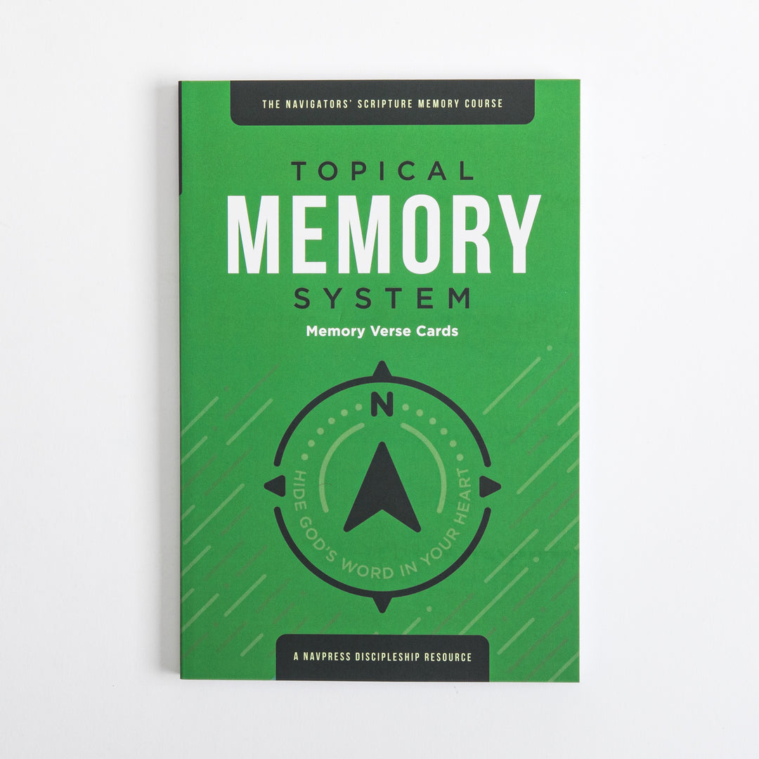 Flat front cover of the green Topical Memory System Memory Verse Cards package, featuring a black compass-arrow icon and the tagline &