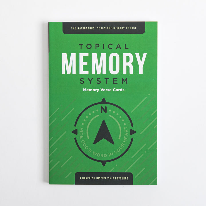 Flat front cover of the green Topical Memory System Memory Verse Cards package, featuring a black compass-arrow icon and the tagline &